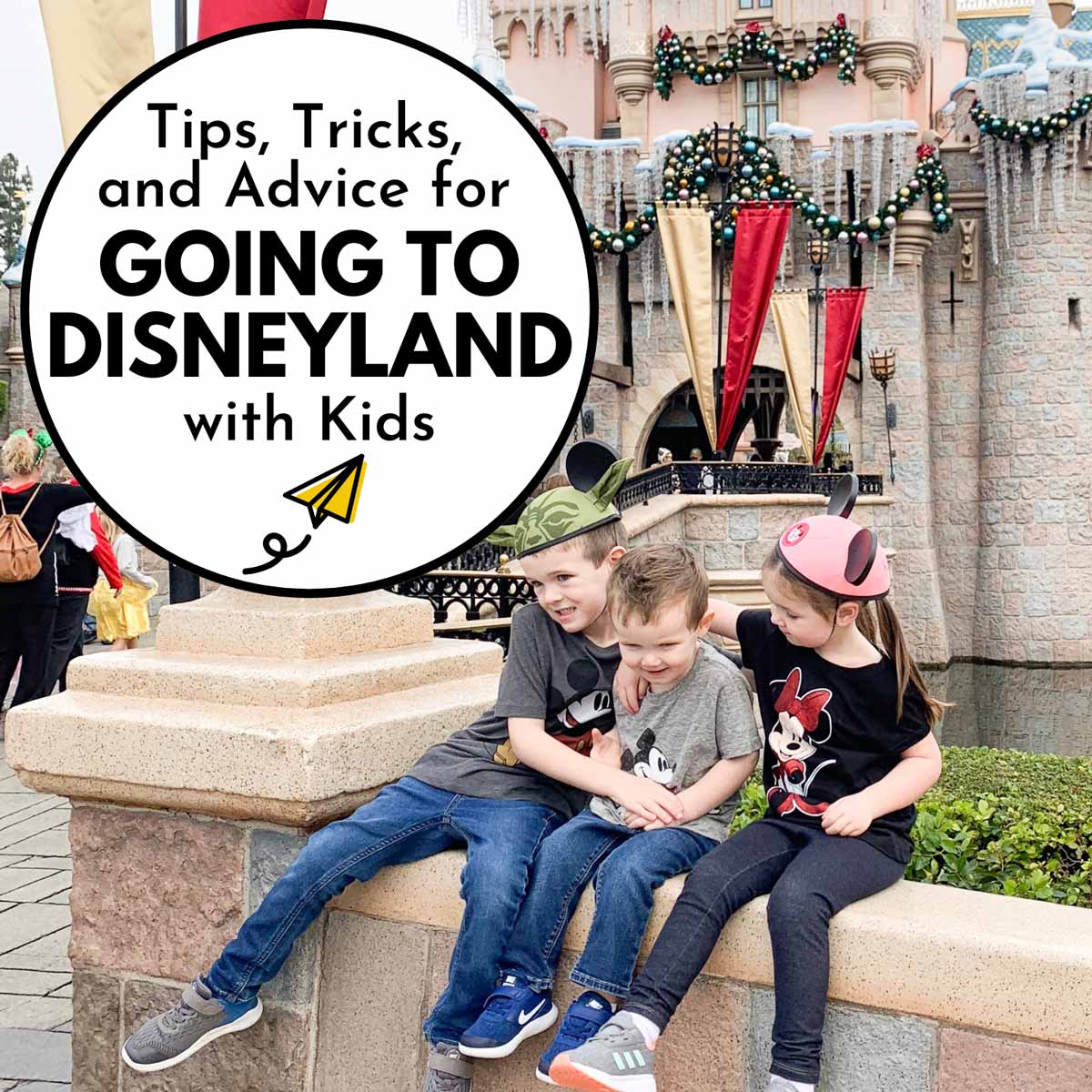 Tips, Tricks, and Advice for Going to Disneyland with Kids: three children sit hugging in front of the Disneyland castle