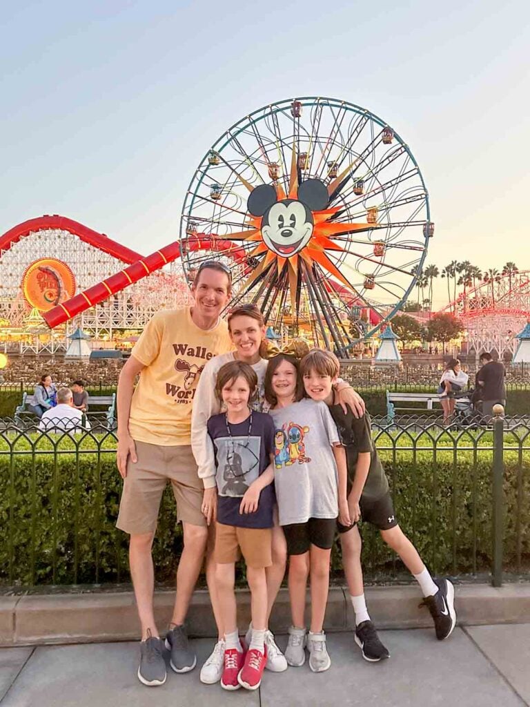 A family stands in front of the Pixar pier at Disney California Adventure.