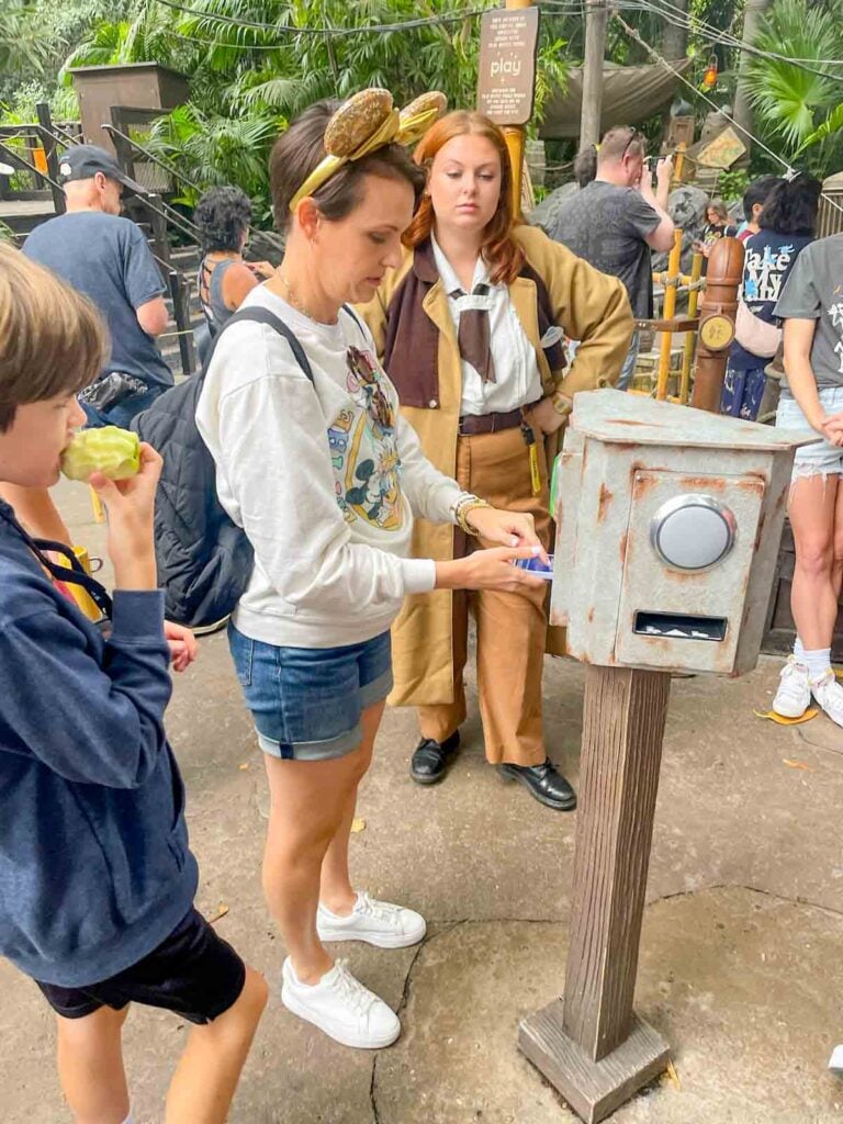 A mom uses the Disneyland app to access the Indiana Jones ride at Disneyland.