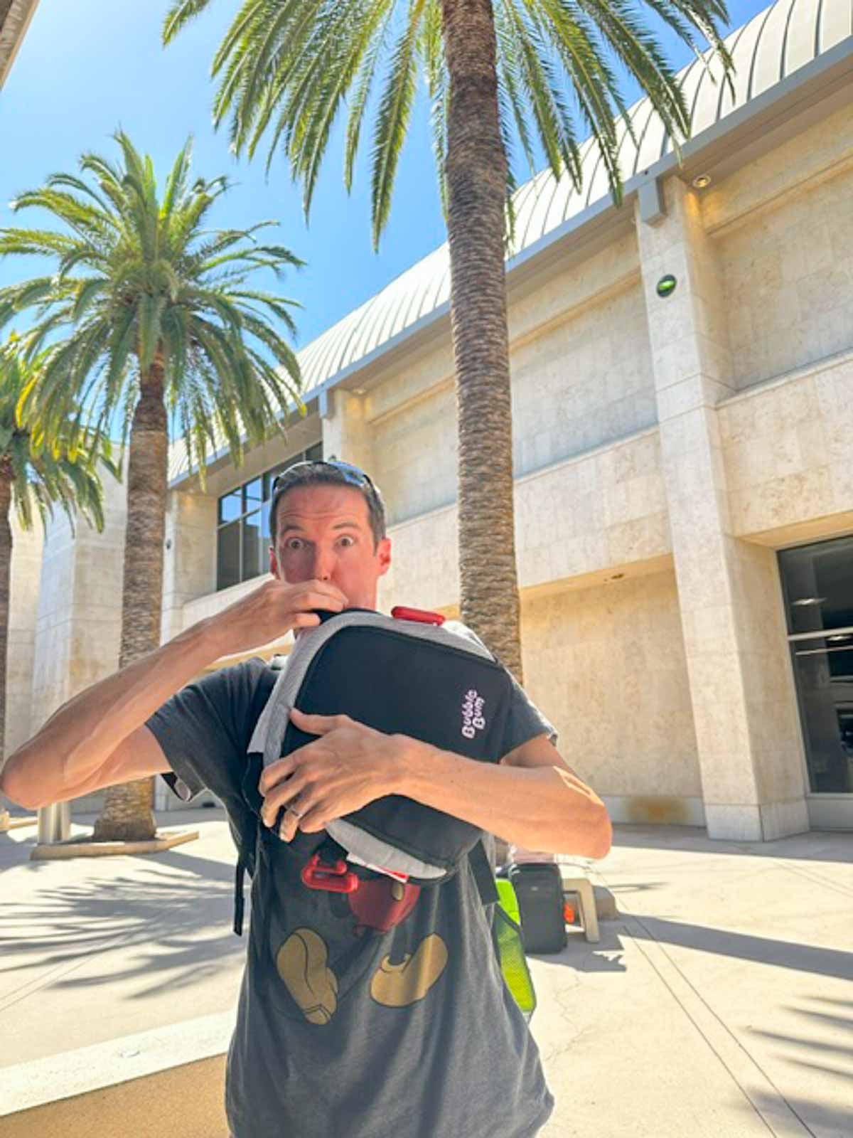 A man inflating booster seats at the Santa Ana Airport.
