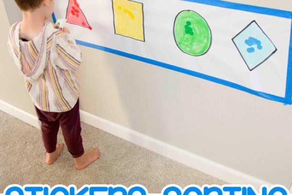 STICKER SHAPES ACTIVITY FOR TODDLERS: A toddler playing with a quick and easy dot sticker activity from Busy Toddler. Working on sorting colors and shape identification in an easy math activity.