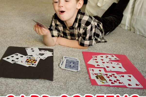Toddler doing a math activity sorting cards in a quick and easy activity from Busy Toddler