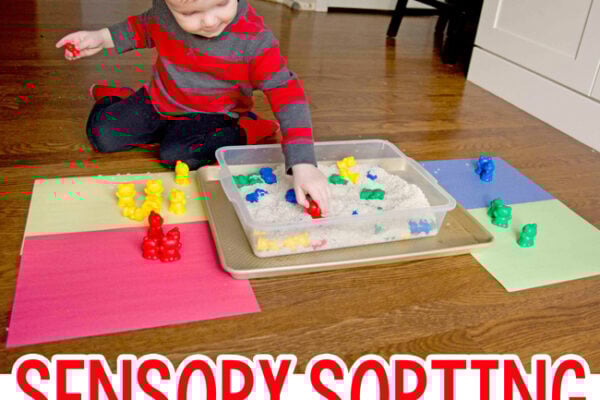 A toddler playing with a sorting and sensory activity from Busy Toddler