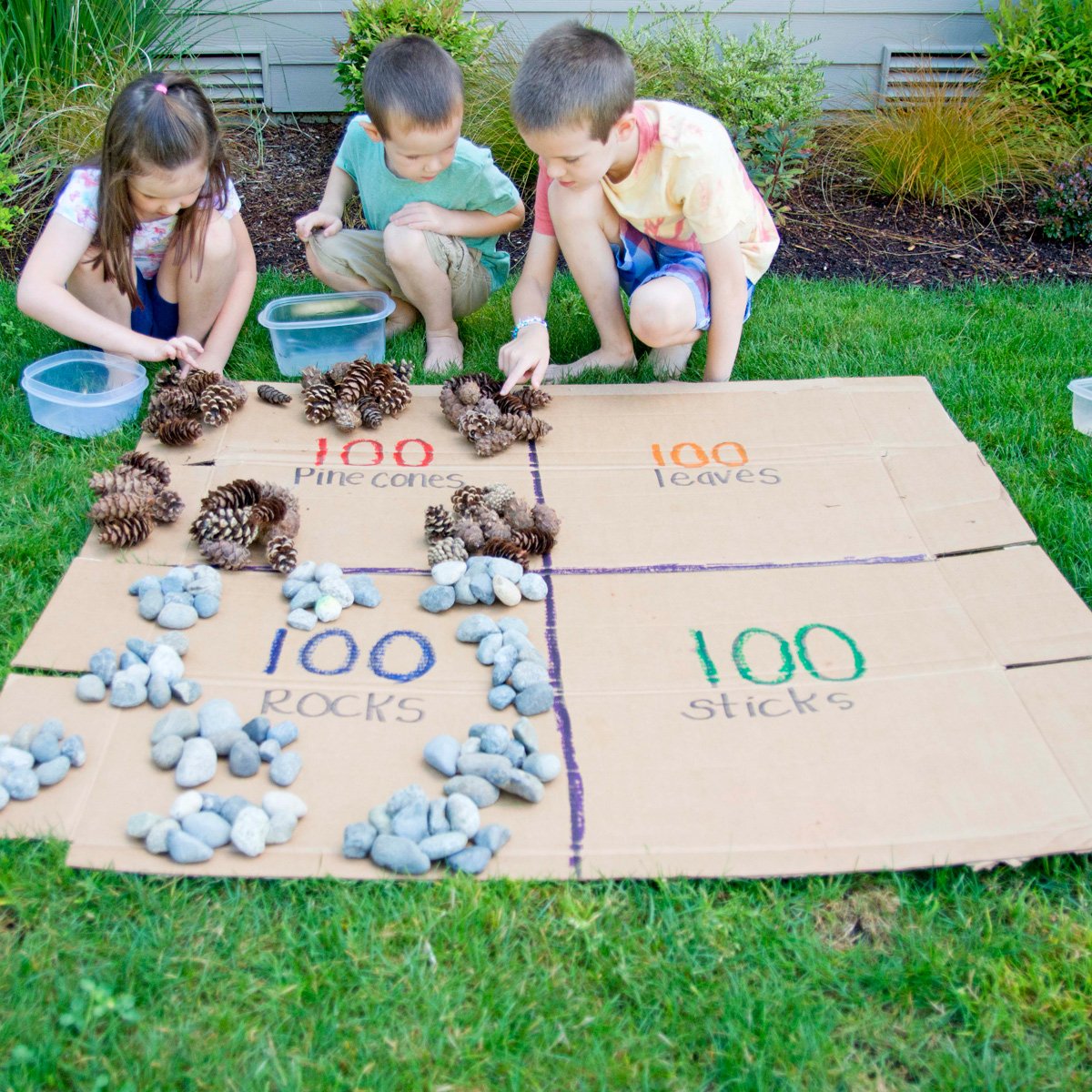 Kids learning about 100 with an outdoor math activity