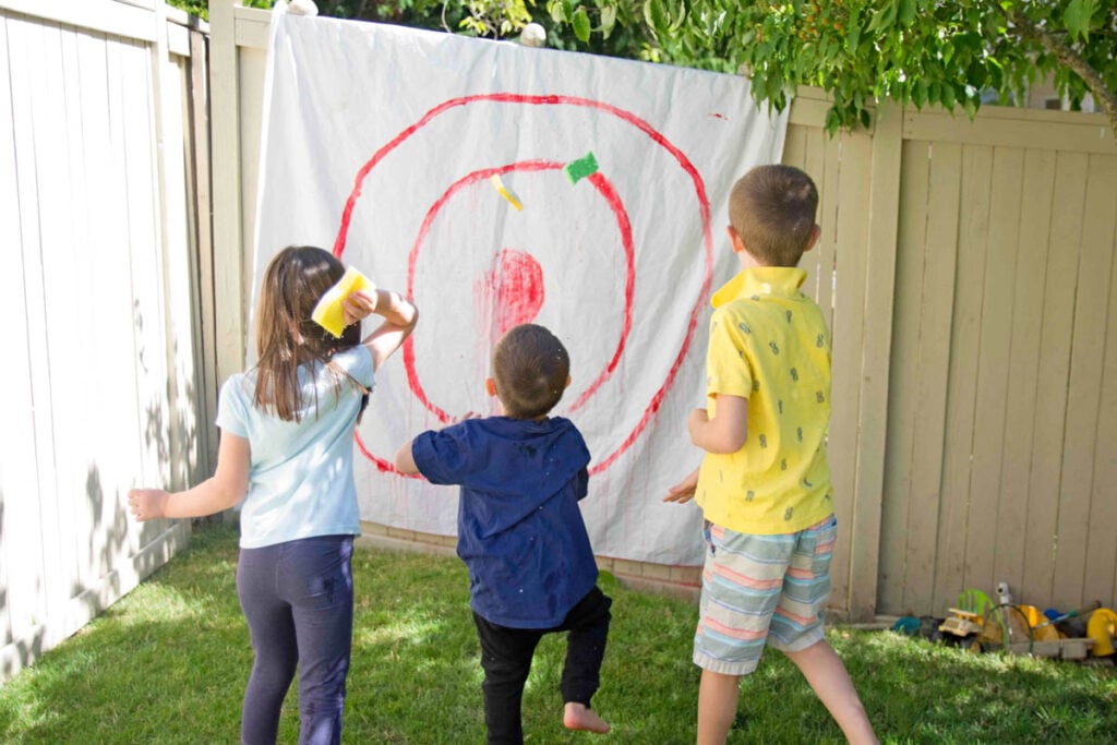 3 kids playing Sponge Targets in the summer