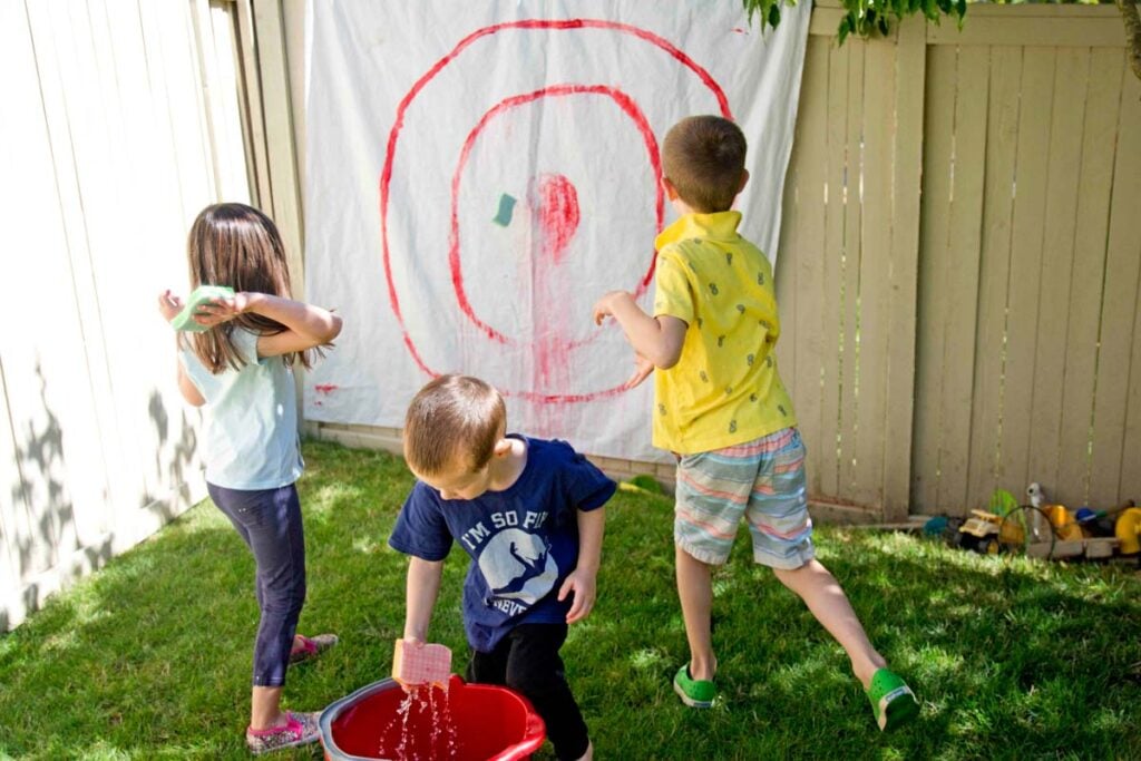 3 kids playing Sponge Targets in the summer