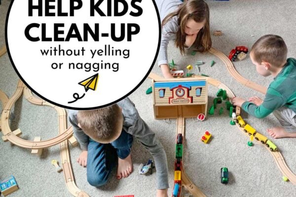How to help kids clean-up without yelling or nagging: image shows three kids on gray carpet playing with trains.