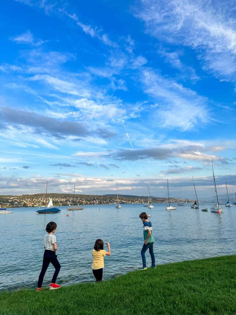 Children playing at the edge of Lake Zurich.