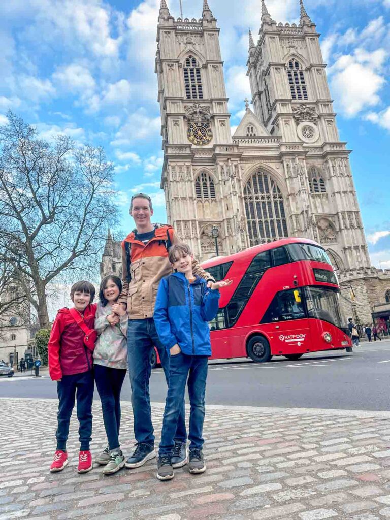 A family stands in front of Westminster Abbey.