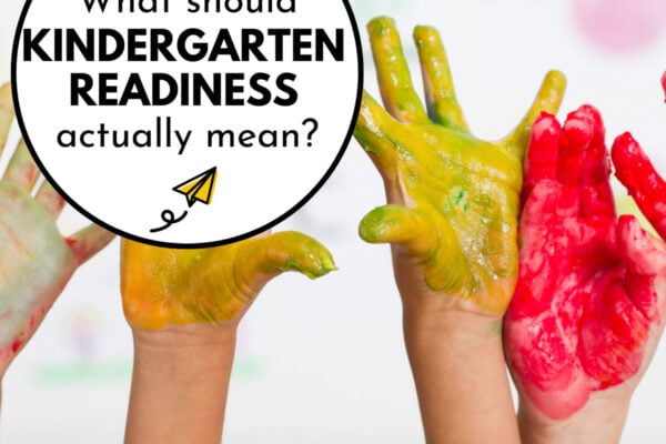 Kid hands covered in paint are raised in the air. The text says "What should kindergarten readiness actually mean?"