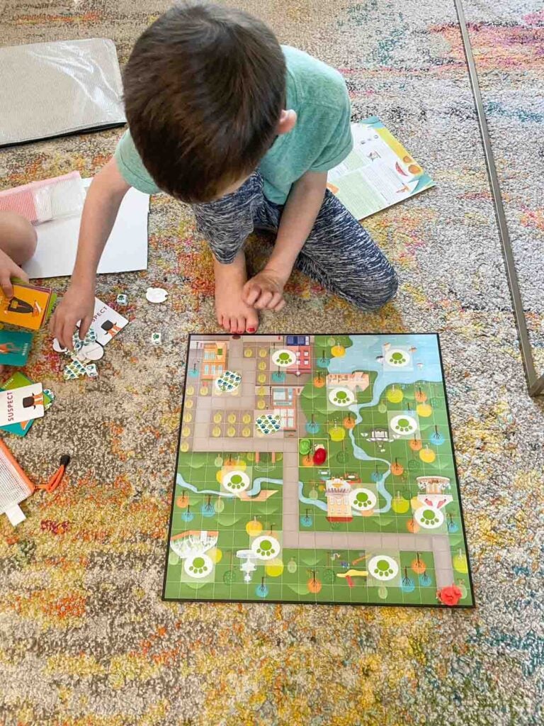 A child plays Outfoxed on a colorful carpet.