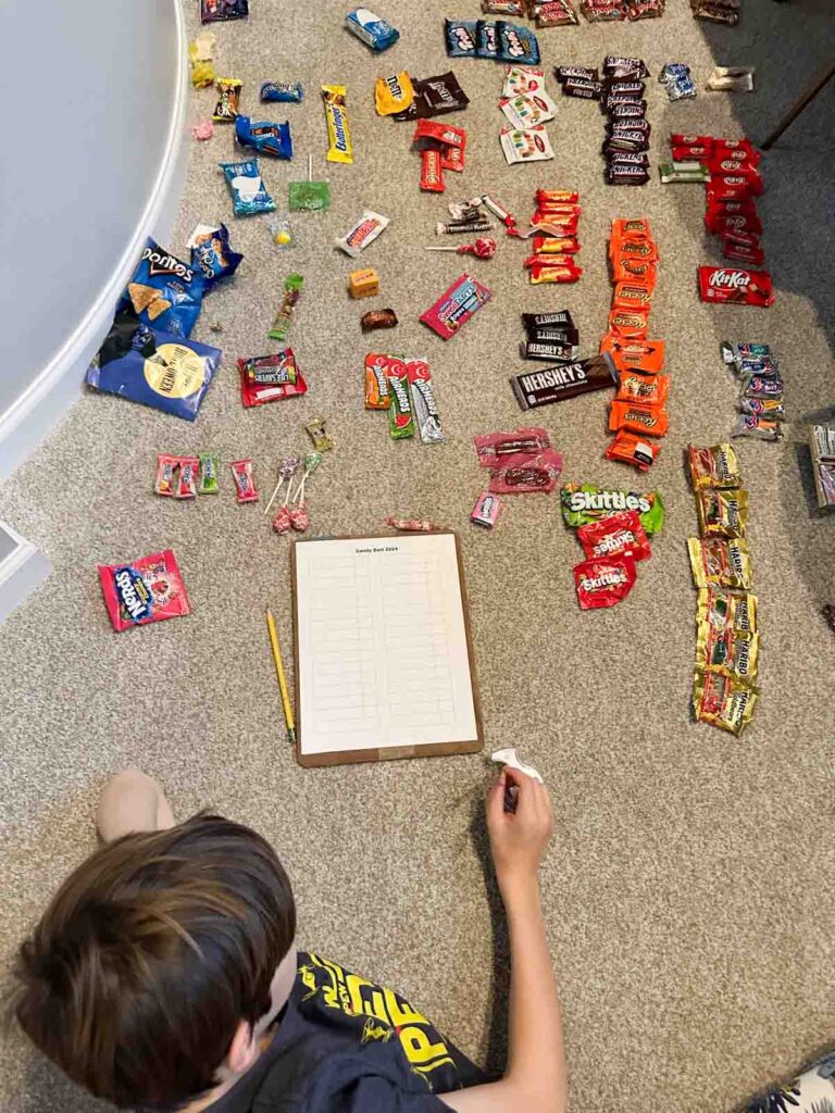 A child sorting piles of candy