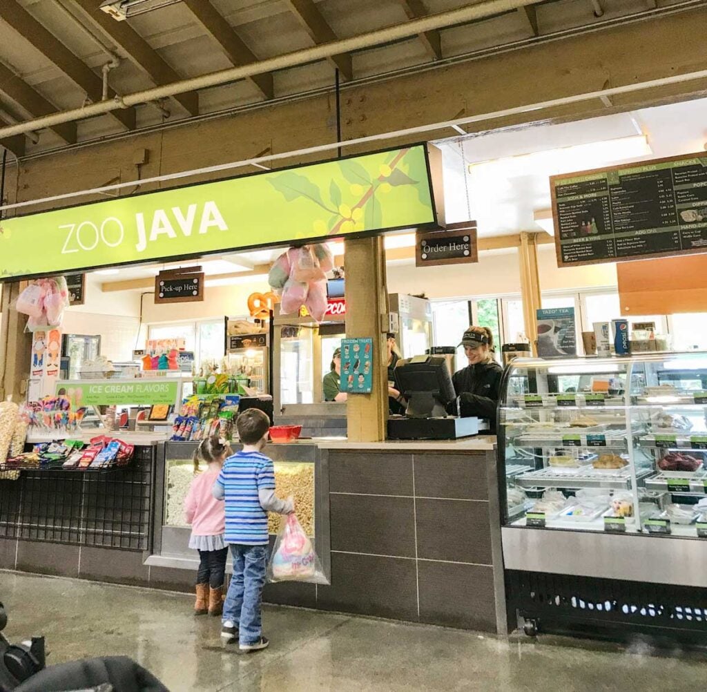 Two preschoolers order cotton candy alone at a zoo.