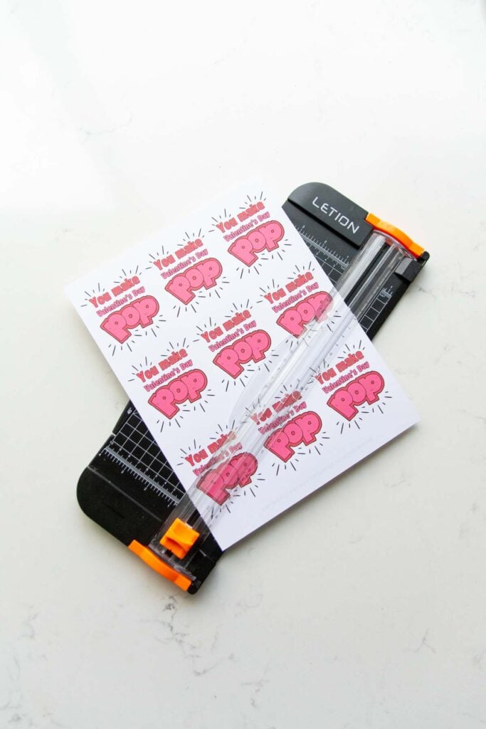 A set of Valentine's read to be trimmed on a paper slicer.