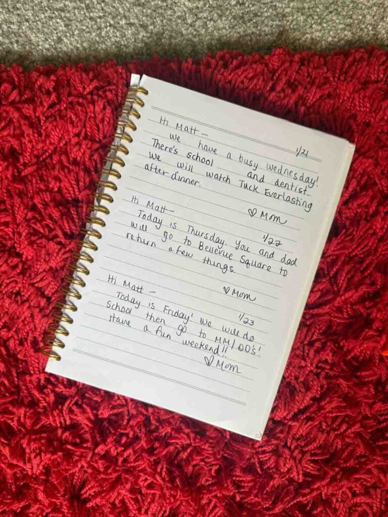 A child's schedule notebook with information about their upcoming day. Three notes are listed.